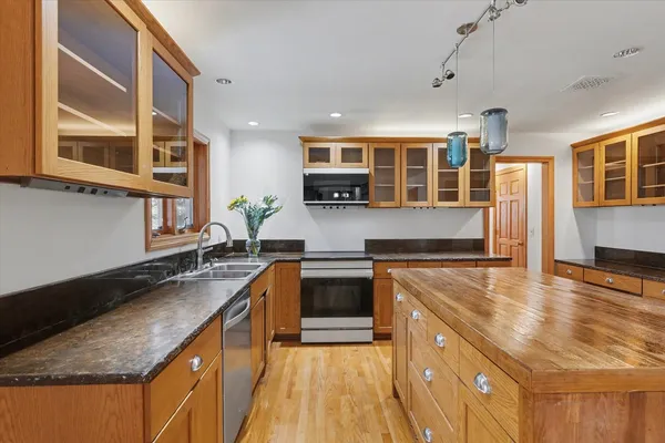 a kitchen with stainless steel appliances granite countertop a sink and cabinets