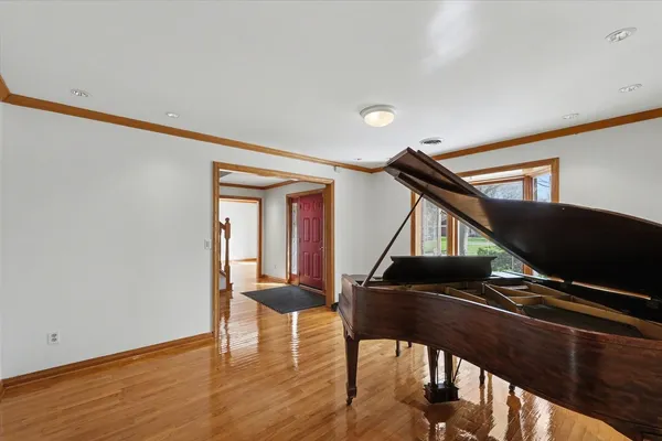 a view of empty room with wooden floor and fireplace