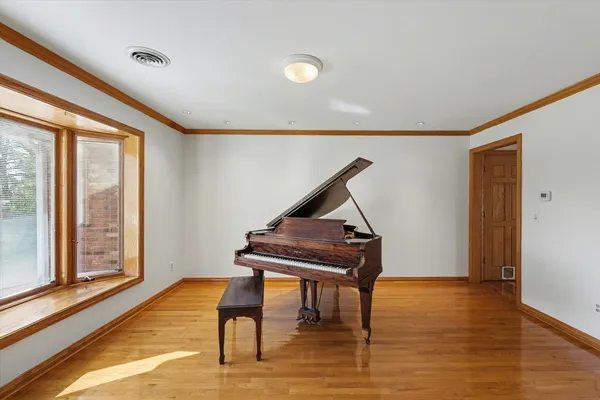a view of empty room with wooden floor and fireplace