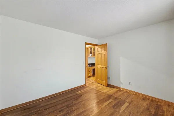 a bedroom with a large bed couch and a window