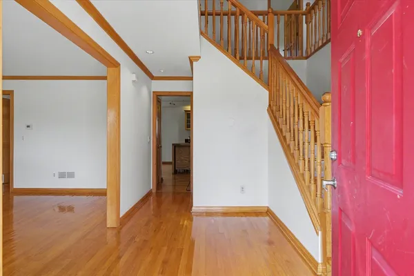 a view of an empty room with wooden floor
