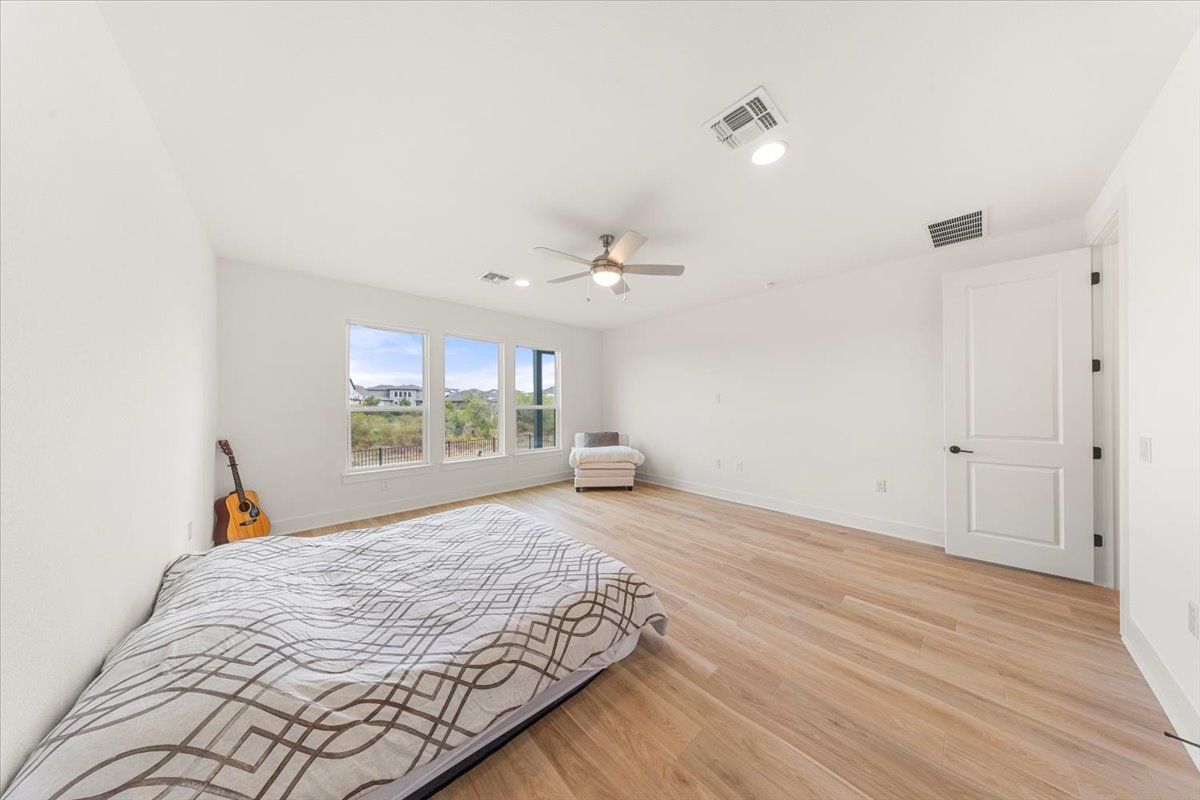 8700 Olmsted Way Austin, TX 78744 - Photo 18 of 40 Bedroom with light wood-style flooring, recessed lighting, and a ceiling fan