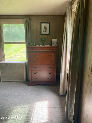 a view of room with window and cabinet