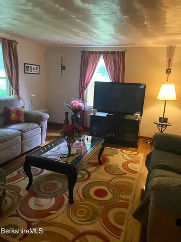 a living room with furniture and a lamp