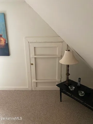 a living room with a table and a lamp