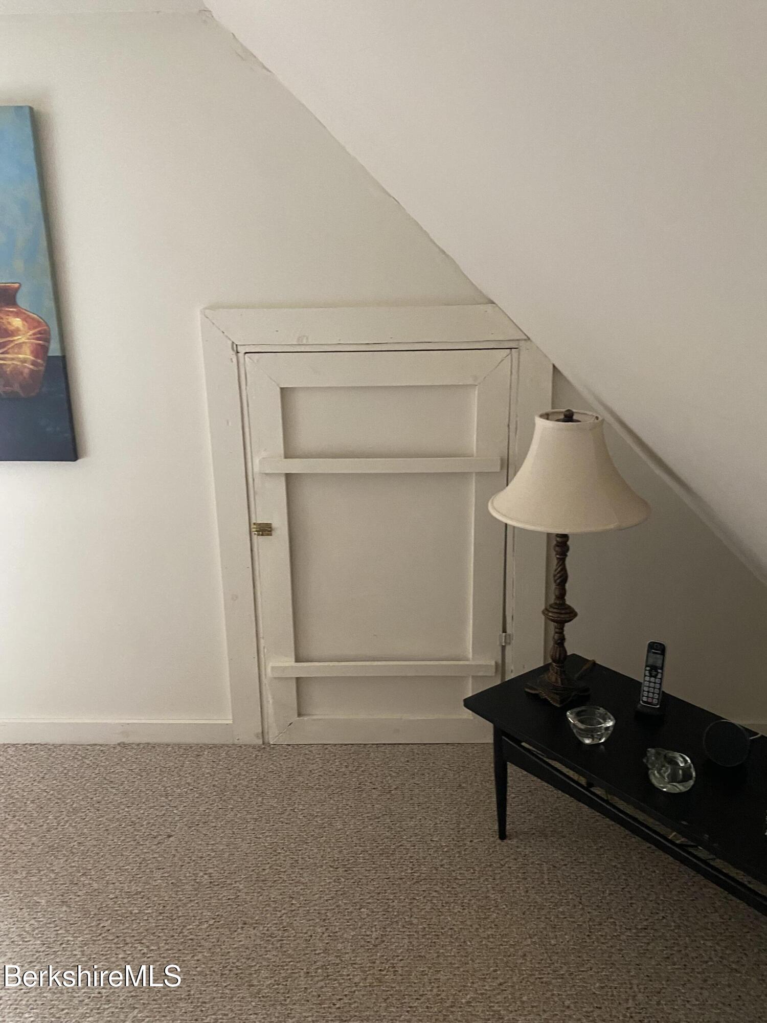 355 Laurel Street Lee, MA 01238 - Photo 9 of 19 a living room with a table and a lamp