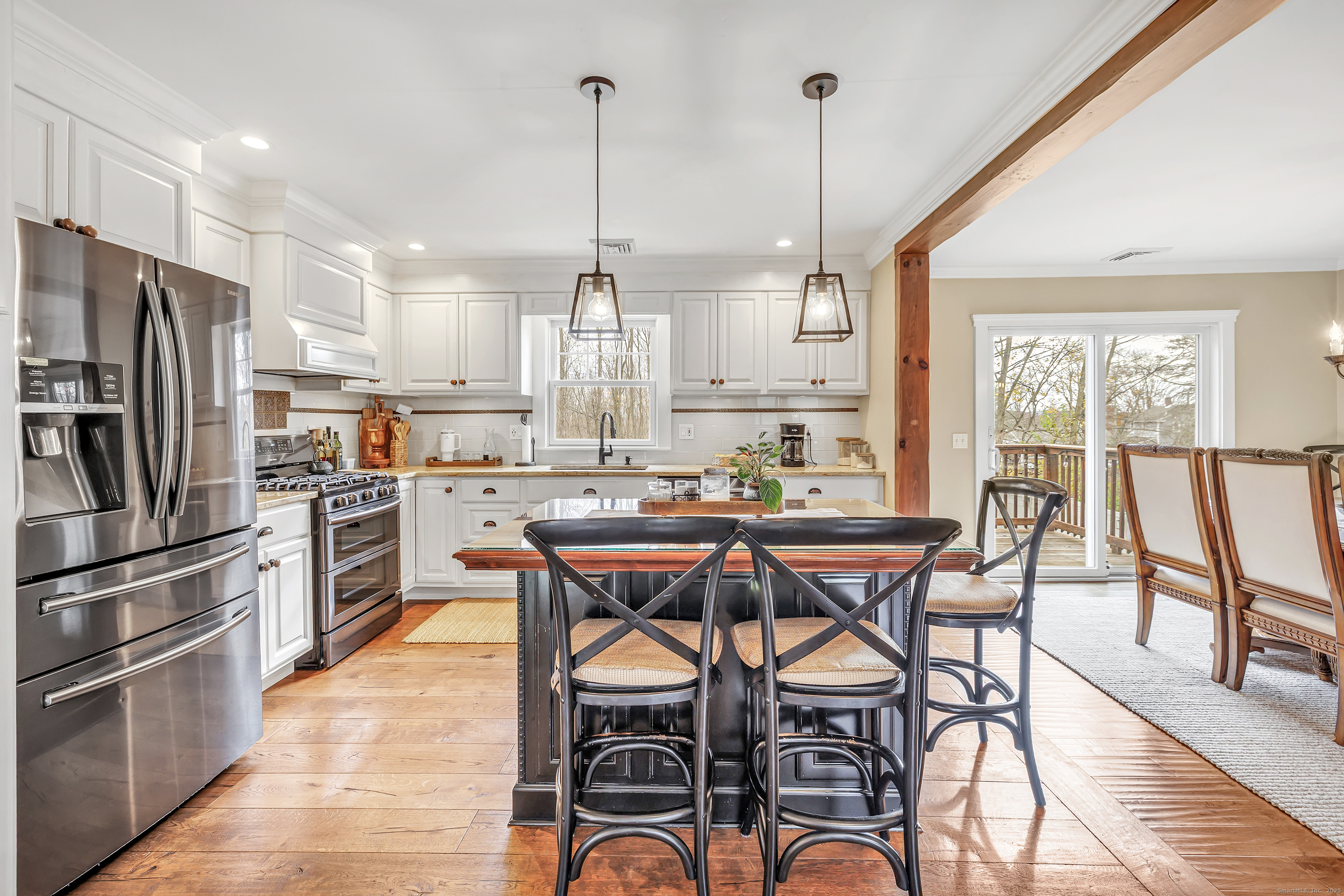 3 Great Meadow Road Danbury, CT 06811 - Photo 15 of 40 a kitchen with stainless steel appliances a dining table chairs stove and refrigerator