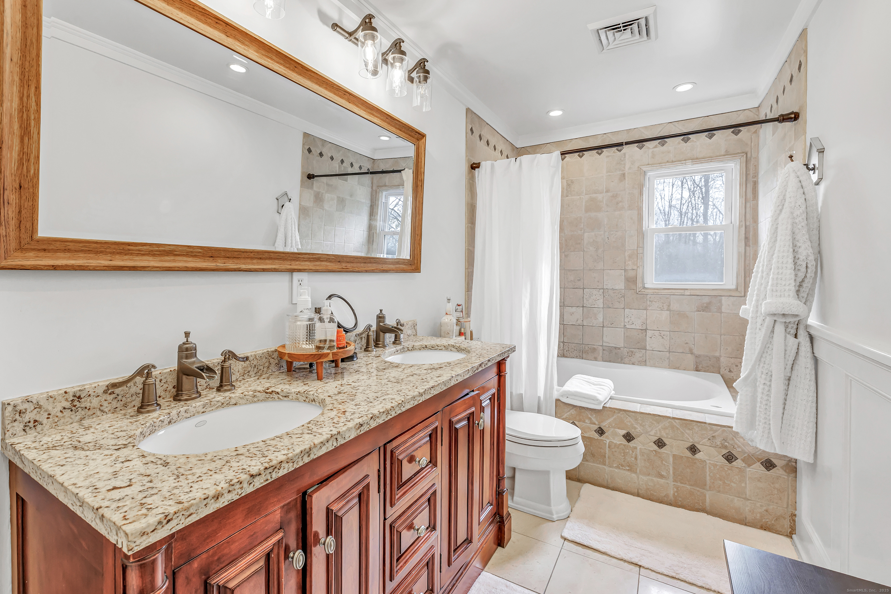 3 Great Meadow Road Danbury, CT 06811 - Photo 24 of 40 a bathroom with a granite countertop sink a toilet a mirror a vanity a bathtub and shower