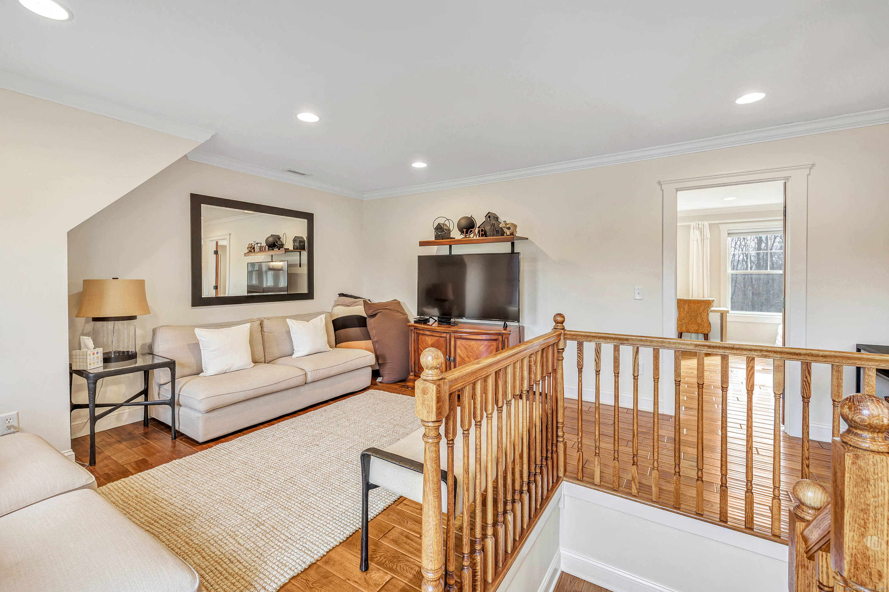 3 Great Meadow Road Danbury, CT 06811 - Photo 28 of 40 a living room with furniture a flat screen tv and a window