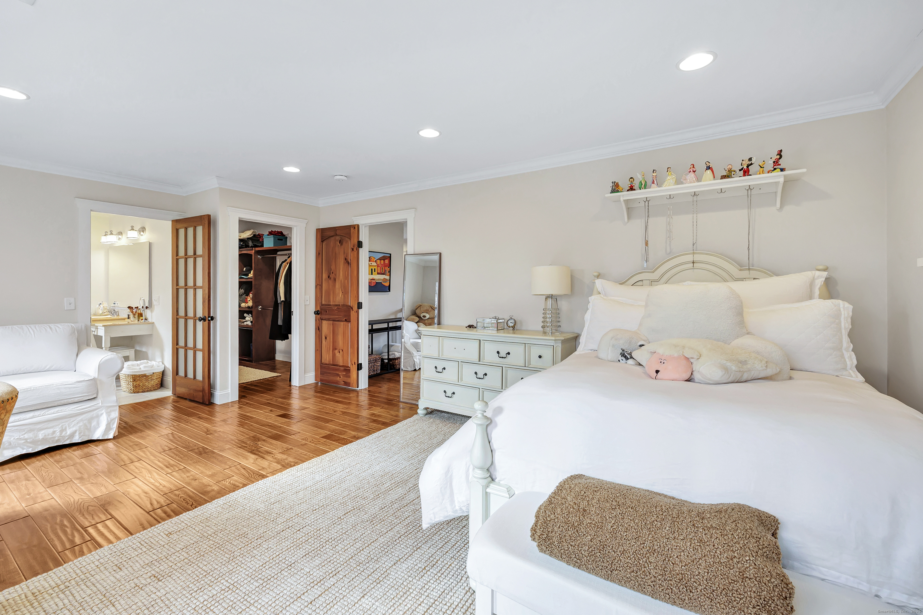 3 Great Meadow Road Danbury, CT 06811 - Photo 32 of 40 a spacious bedroom with a bed a couch and a large window