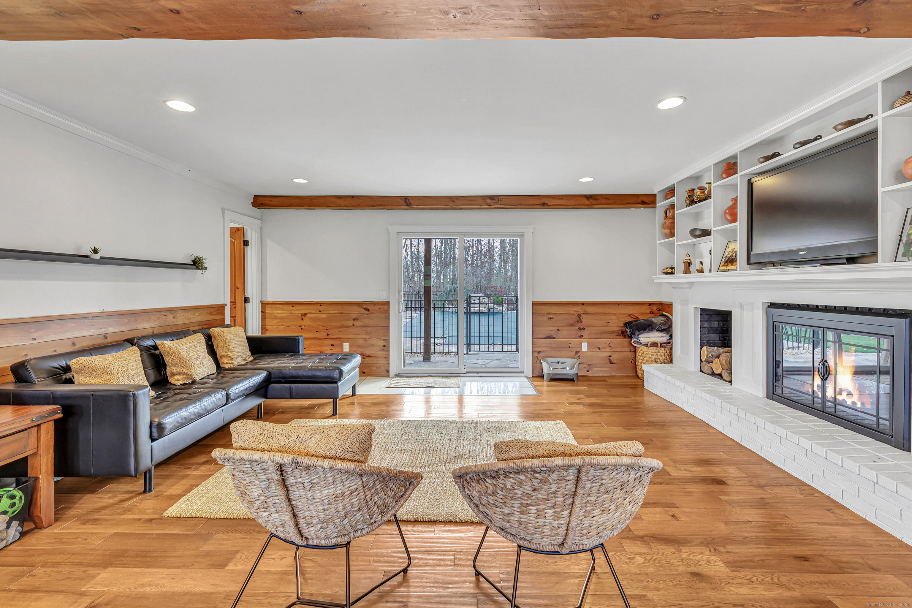 3 Great Meadow Road Danbury, CT 06811 - Photo 39 of 40 a living room with fireplace furniture and a flat screen tv