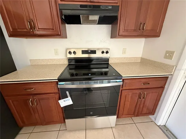 a stove top oven sitting inside of a kitchen