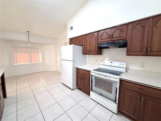 a kitchen with a stove a sink and a refrigerator
