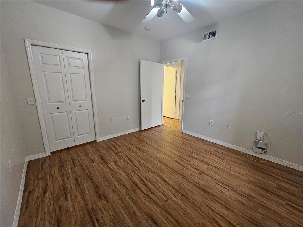 5174 Northridge Road, Unit 209 Sarasota, FL 34238 - Photo 11 of 25 a view of an empty room with wooden floor and a window