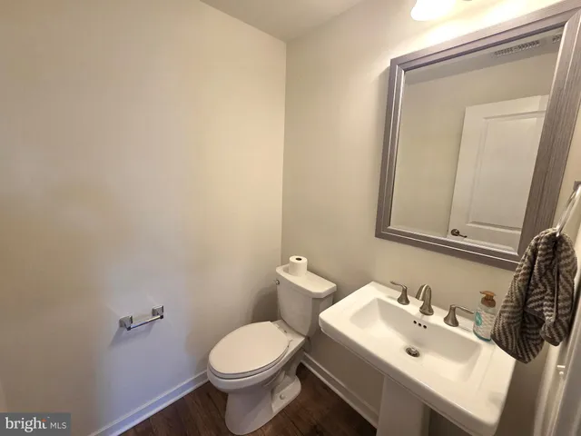 a bathroom with a sink mirror and toilet