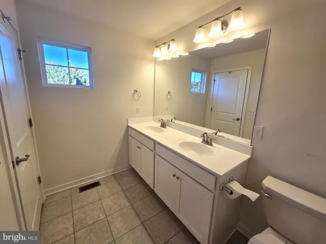 a bathroom with a sink toilet and mirror