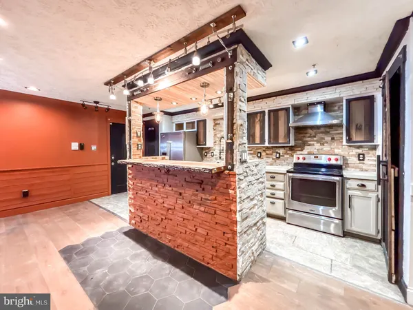 a kitchen with stainless steel appliances granite countertop a stove and a sink