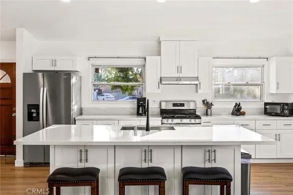 a kitchen with stainless steel appliances a sink and cabinets