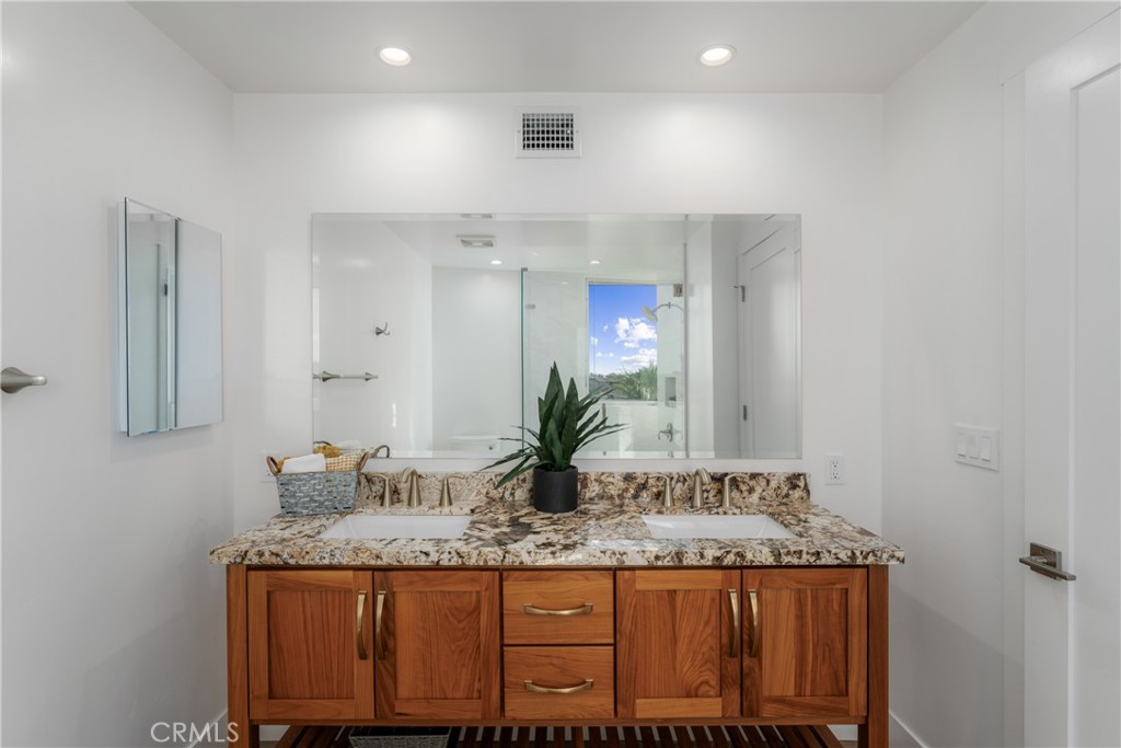 2648 State Street Carlsbad, CA 92008 - Photo 15 of 24 a bathroom with a granite countertop sink and a mirror