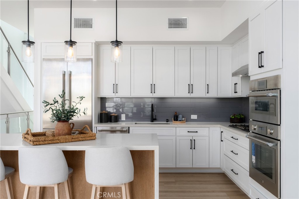 2648 State Street Carlsbad, CA 92008 - Photo 2 of 24 a kitchen with stainless steel appliances a sink a stove a microwave and cabinets