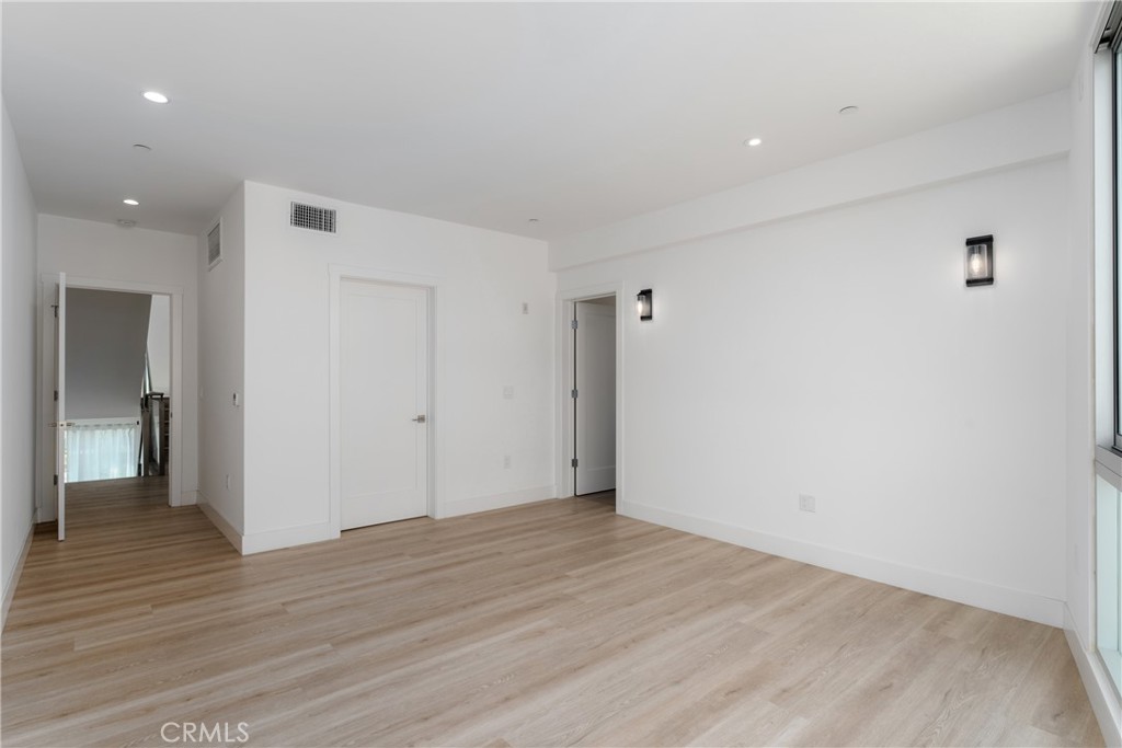 2648 State Street Carlsbad, CA 92008 - Photo 10 of 24 a view of an empty room with wooden floor and a bathroom