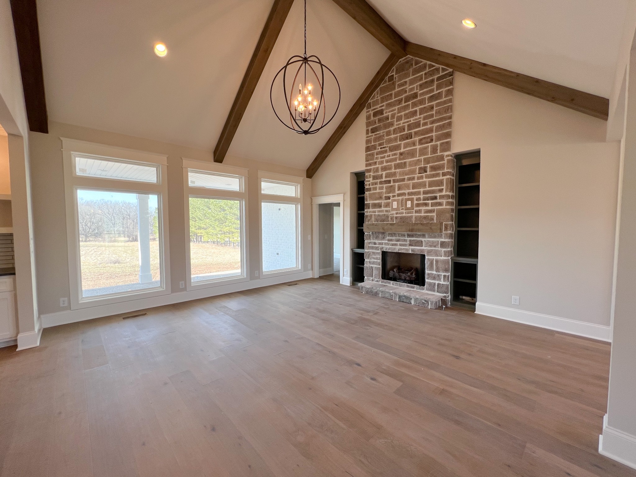 2040 Cairo Bend Road Lebanon, TN 37087 - Photo 8 of 38 a view of an empty room with a fireplace and a window