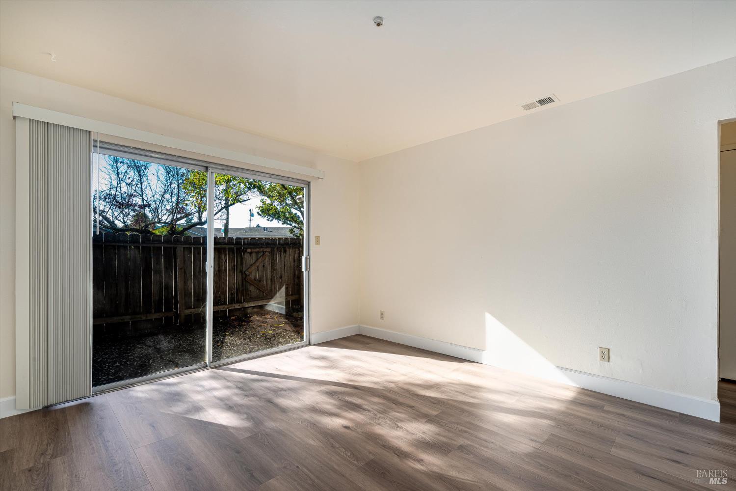 220-226 Arlen Drive Rohnert Park, CA 94928 - Photo 25 of 56 a view of an empty room with wooden floor and a window