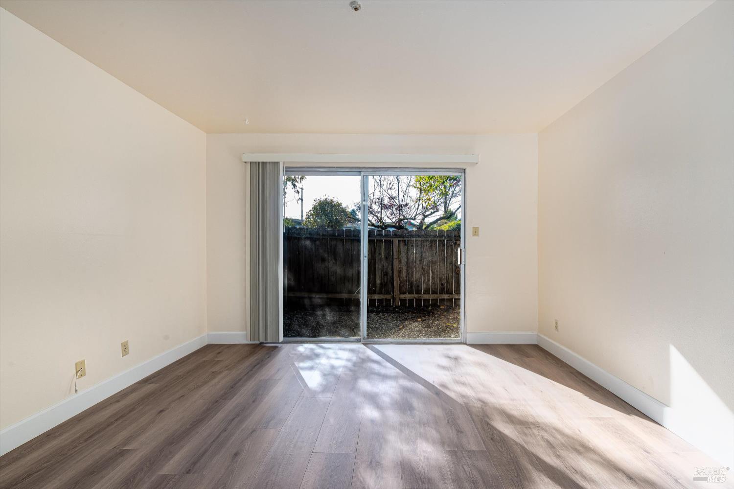 220-226 Arlen Drive Rohnert Park, CA 94928 - Photo 26 of 56 an empty room with wooden floor and windows