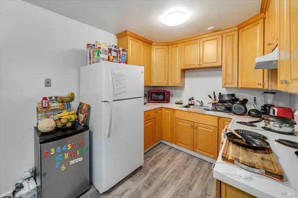 an aerial view of a house with a yard and wooden fence