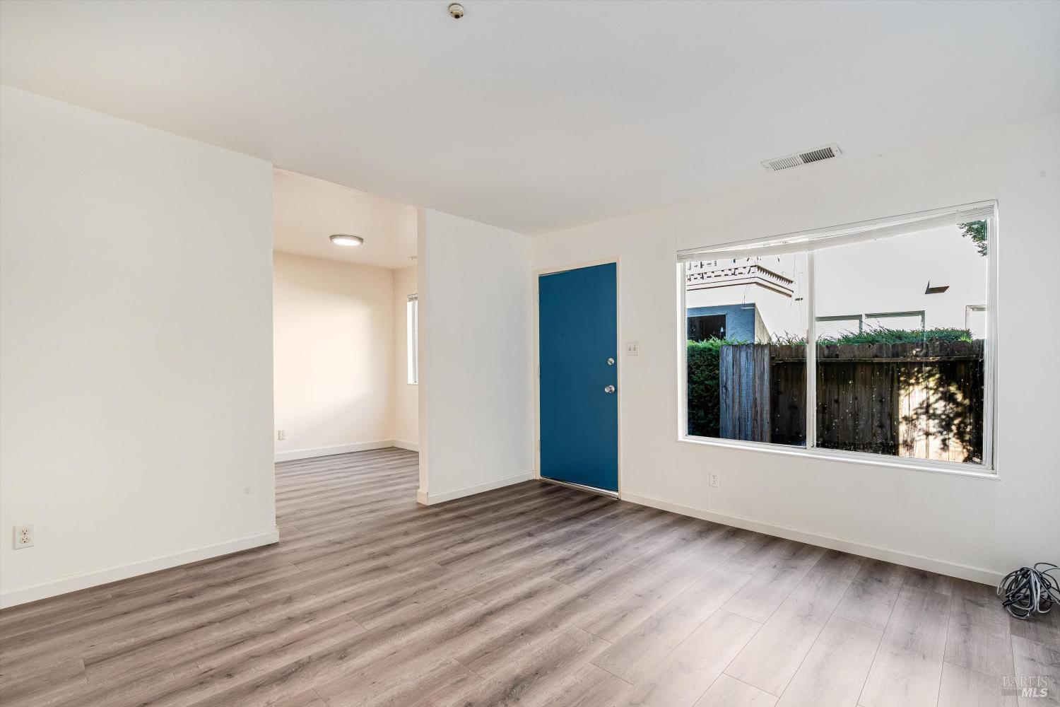 220-226 Arlen Drive Rohnert Park, CA 94928 - Photo 8 of 56 a view of an empty room with wooden floor and a window