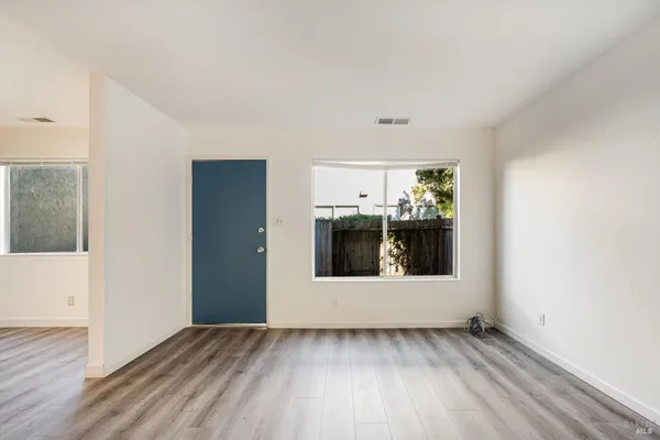 a kitchen with a refrigerator sink and cabinets