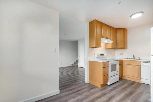 a kitchen with a stove cabinets and a refrigerator