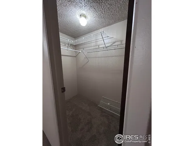 a view of hallway with walk in closet and window