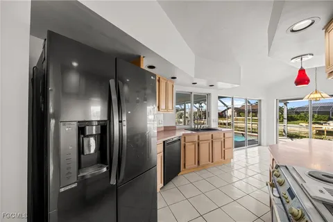 a kitchen with stainless steel appliances granite countertop a sink and cabinets