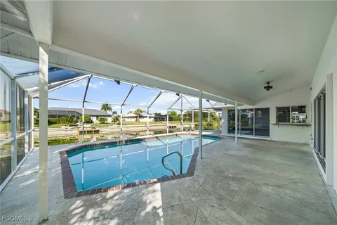 a room with lots of white furniture and windows