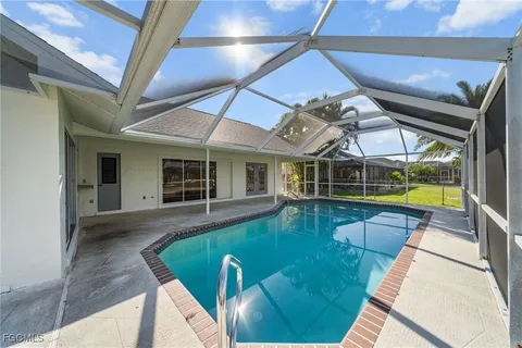 a view of a swimming pool with an outdoor seating