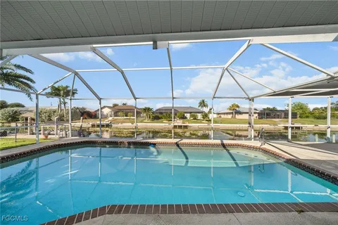 a view of house with swimming pool and yard