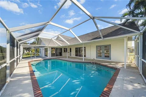 a view of a house with swimming pool and sitting area