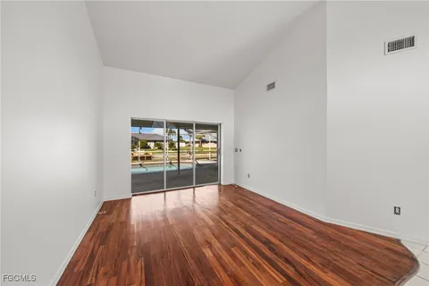 a view of a room with wooden floor