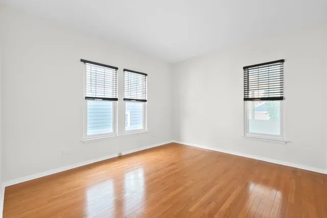 an empty room with large windows and city view