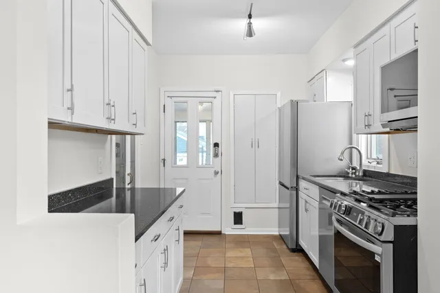 a bedroom with a bed couch and a mirror