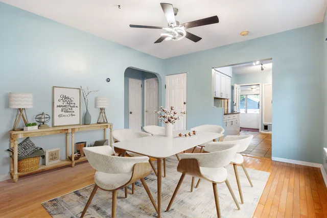 a view of a big room with wooden floor and a ceiling fan