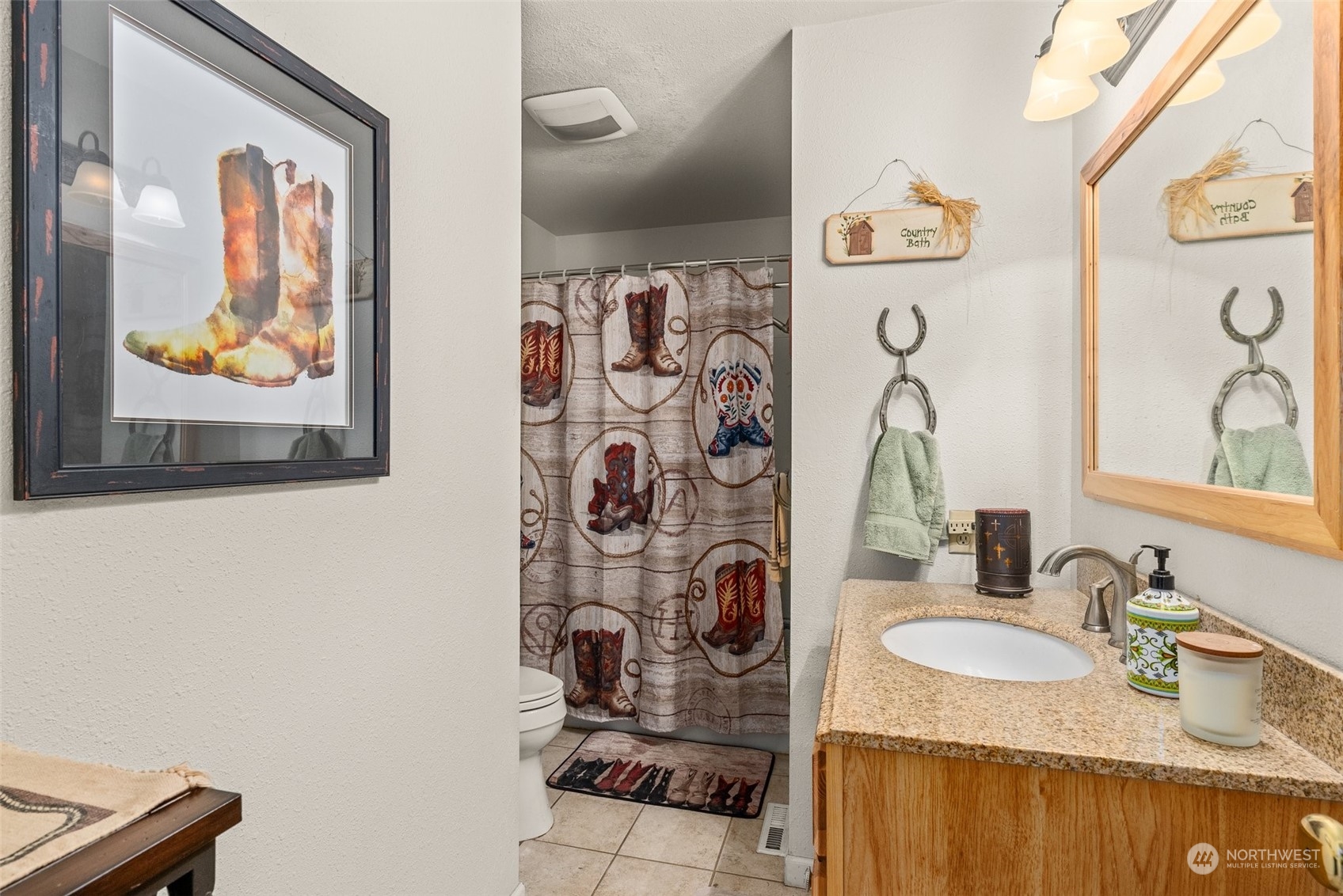 10104 Albany Place Southwest Rochester, WA 98579 - Photo 20 of 31 a bathroom with a sink vanity and mirror