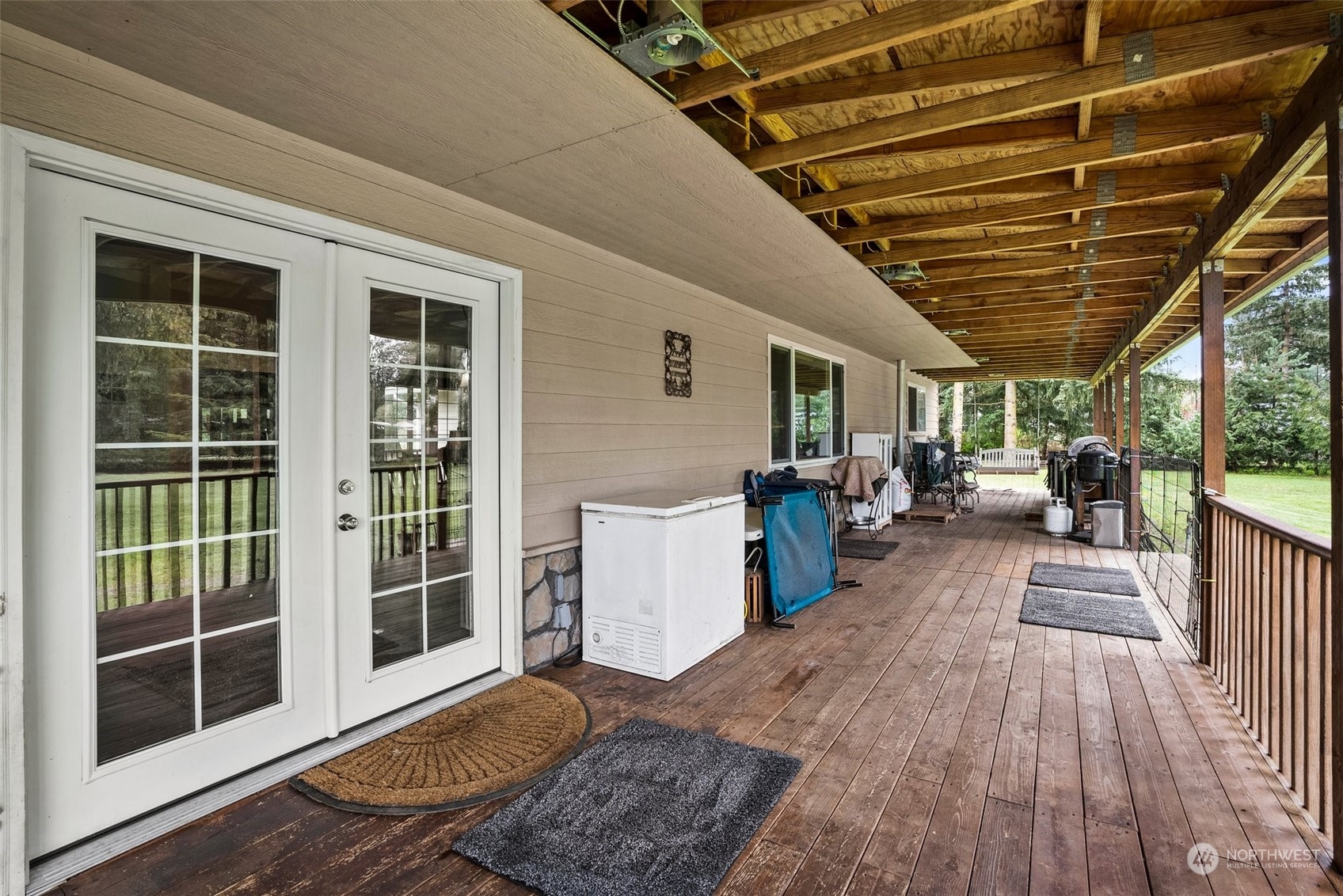 10104 Albany Place Southwest Rochester, WA 98579 - Photo 21 of 31 a view of a porch with wooden floor and iron stairs