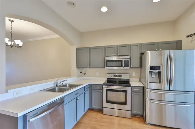 a kitchen with a sink a stove and refrigerator
