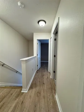a view of hallway with wooden floor