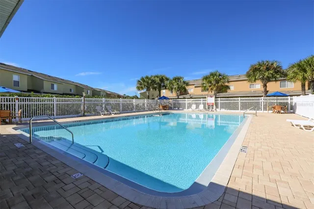a view of a swimming pool with a deck