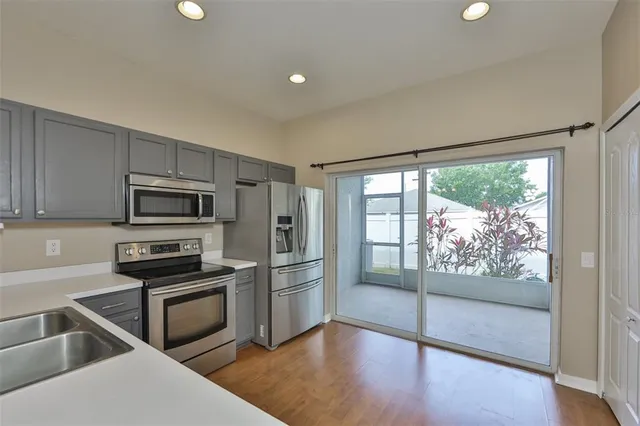 a kitchen with wooden cabinets and stainless steel appliances