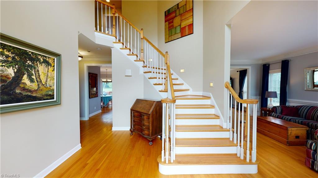 2610 Oxmoor Road Summerfield, NC 27358 - Photo 2 of 31 Gracious Curved staircase in two-story entry
