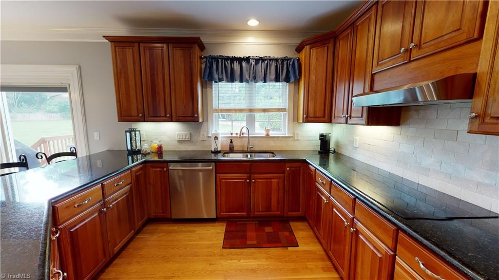 2610 Oxmoor Road Summerfield, NC 27358 - Photo 5 of 31 Kitchen with Granite Tops & Tile backsplash